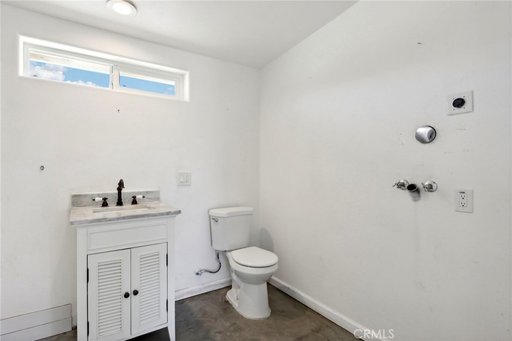 51474 Mills Road Johnson Valley, CA 92285 - Photo 26 of 56 a bathroom with a toilet a sink and mirror