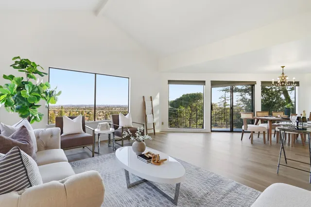 a large kitchen with stainless steel appliances granite countertop a sink and wooden cabinets