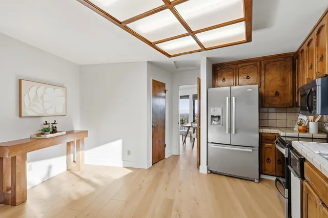 a living room with furniture a dining table and chairs with kitchen view