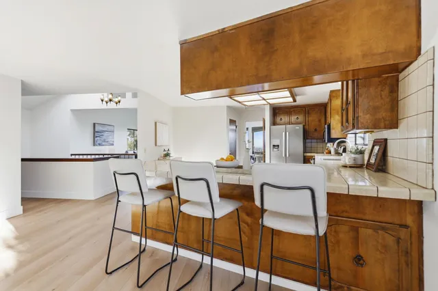 a dining room with furniture a chandelier and wooden floor