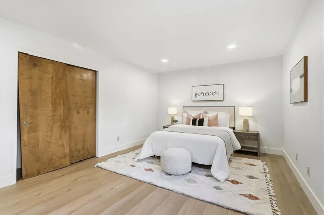 a bedroom with a large bed and a window