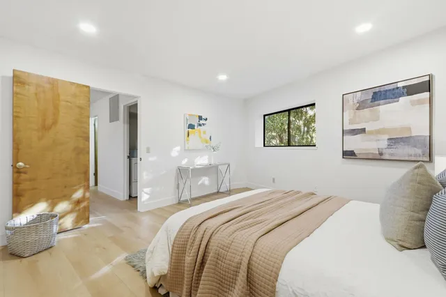 a spacious bedroom with a bed and a table in it