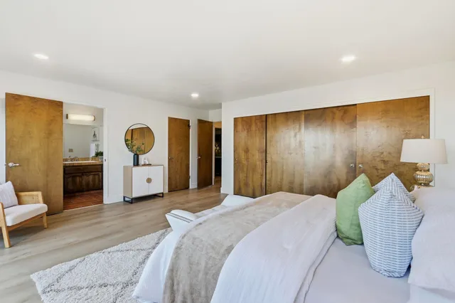 a bathroom with a granite countertop toilet sink and mirror