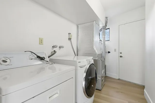 a view of a chairs and table in patio next to a yard