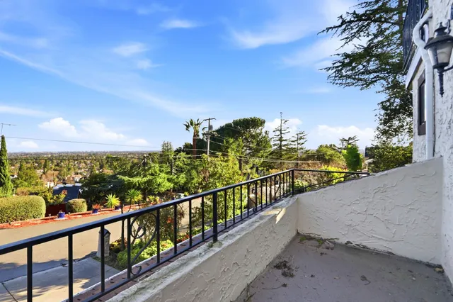 a view of patio with table and chairs and potted plants