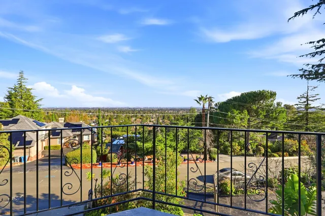 an aerial view of a house with a yard and large trees