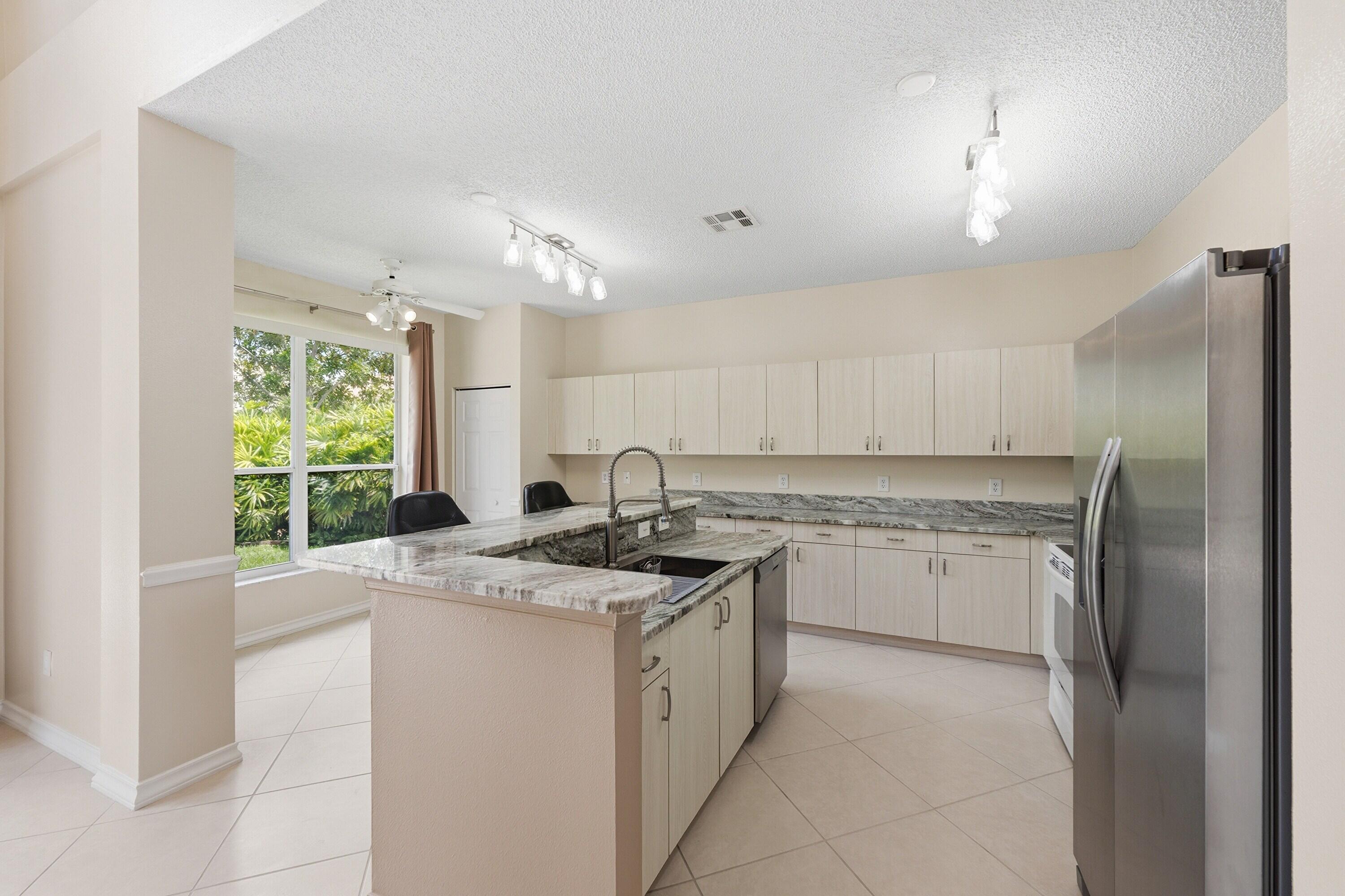 18474 Old Princeton Lane Boca Raton, FL 33498 - Photo 16 of 46 a kitchen with a sink stove and refrigerator