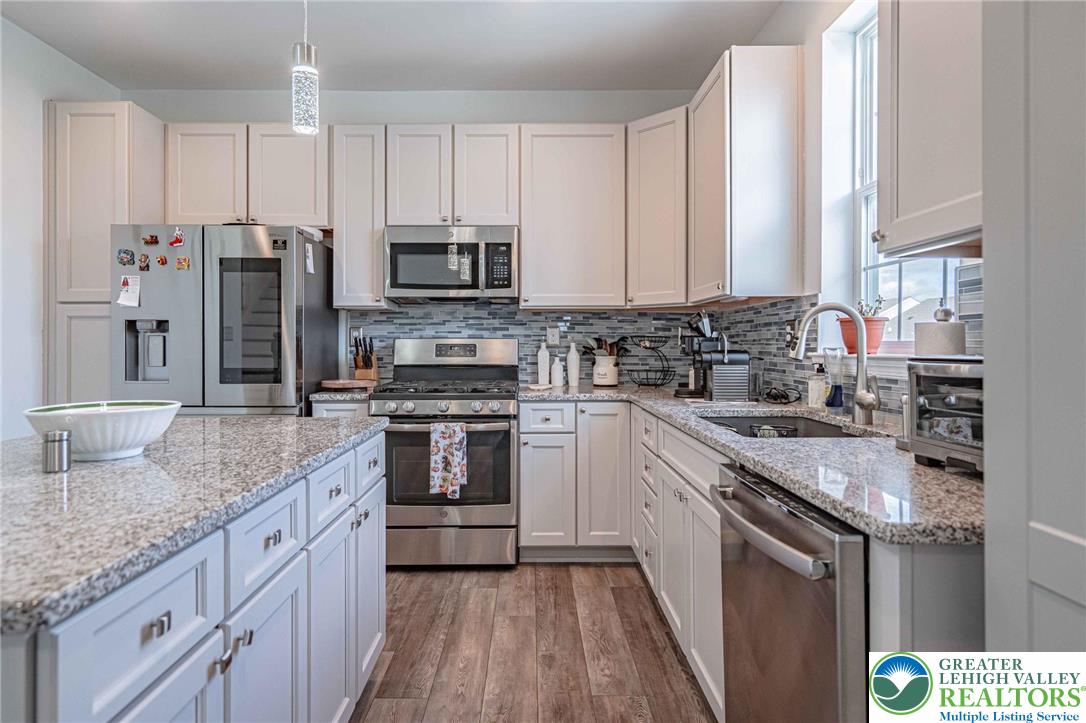 4435 Stole Road Emmaus, PA 18049 - Photo 17 of 64 a kitchen with stainless steel appliances granite countertop a sink stove and refrigerator
