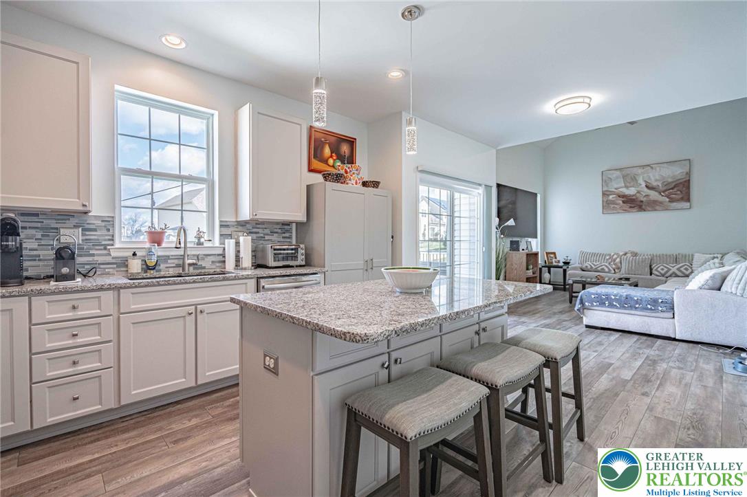 4435 Stole Road Emmaus, PA 18049 - Photo 19 of 64 a open kitchen with stainless steel appliances granite countertop a stove a sink a dining table and chairs