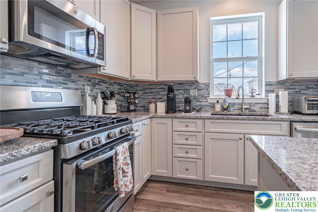 4435 Stole Road Emmaus, PA 18049 - Photo 20 of 64 a kitchen with granite countertop a stove sink and cabinets