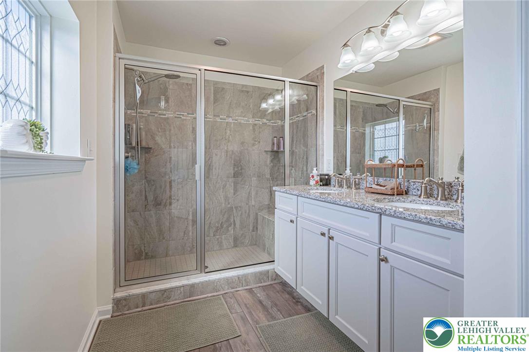4435 Stole Road Emmaus, PA 18049 - Photo 36 of 64 a bathroom with a shower sink and mirror