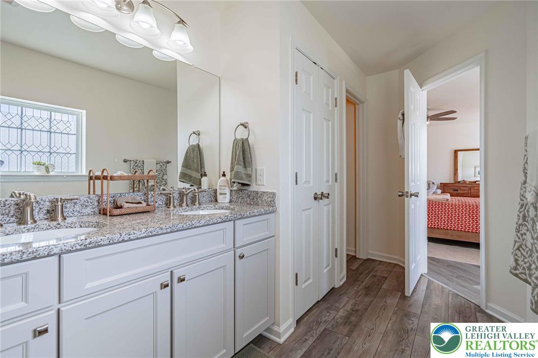 4435 Stole Road Emmaus, PA 18049 - Photo 37 of 64 a en suite bathroom with a granite countertop sink and a mirror