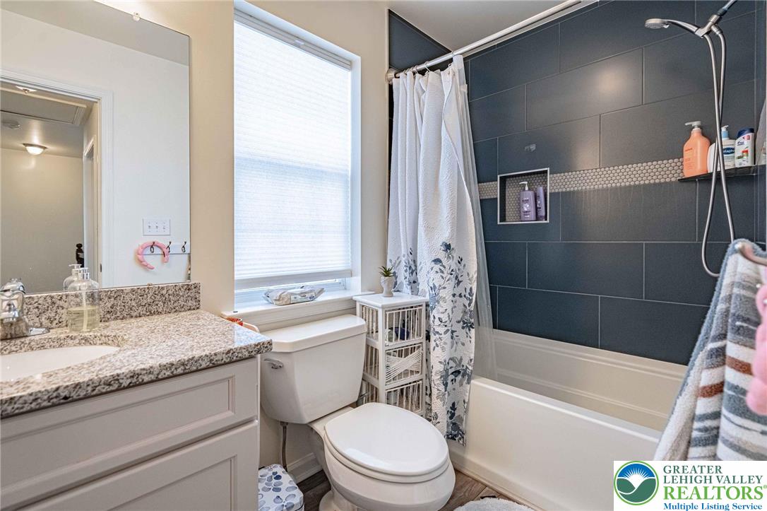 4435 Stole Road Emmaus, PA 18049 - Photo 45 of 64 a bathroom with a granite countertop toilet a sink and a bathtub