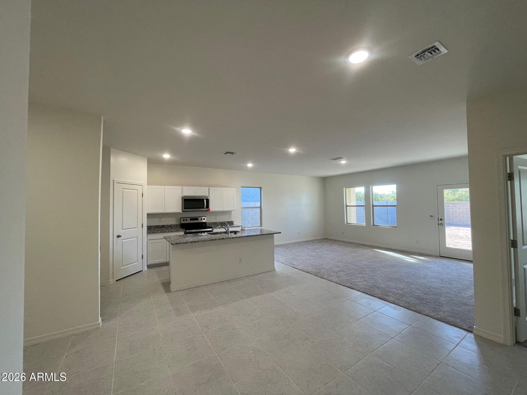 2152 Night Rider Road San Tan Valley, AZ 85140 - Photo 2 of 11 a living room with stainless steel appliances granite countertop furniture and a fireplace