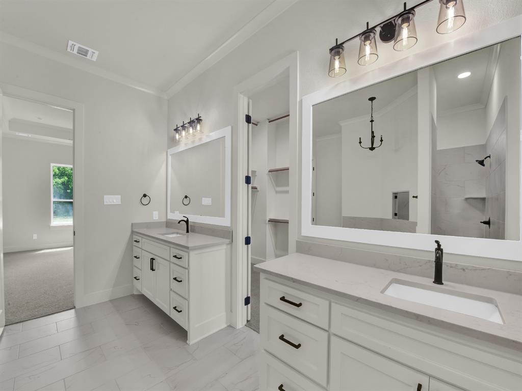 305 Wrangler Court Weatherford, TX 76088 - Photo 28 of 32 a spacious bathroom with double sink and mirror