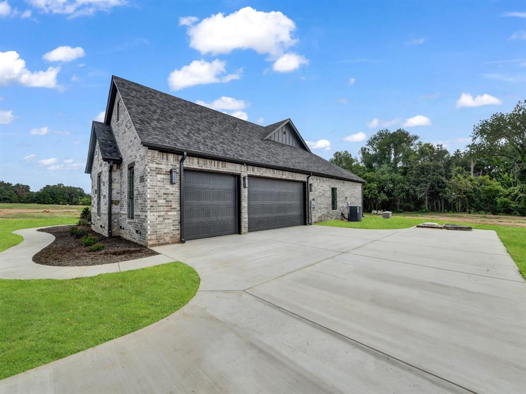 305 Wrangler Court Weatherford, TX 76088 - Photo 8 of 32 a view of a house with backyard and a garden