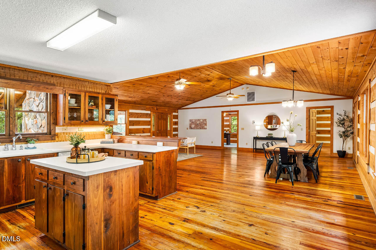 1114 Phil's Ridge Road Chapel Hill, NC 27516 - Photo 12 of 52 a view of a dining room with furniture window and wooden floor