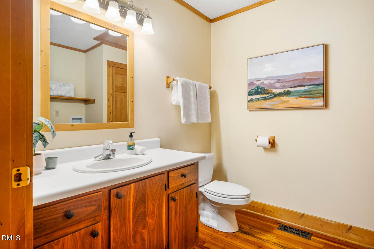 1114 Phil's Ridge Road Chapel Hill, NC 27516 - Photo 16 of 52 a bathroom with a sink and a mirror