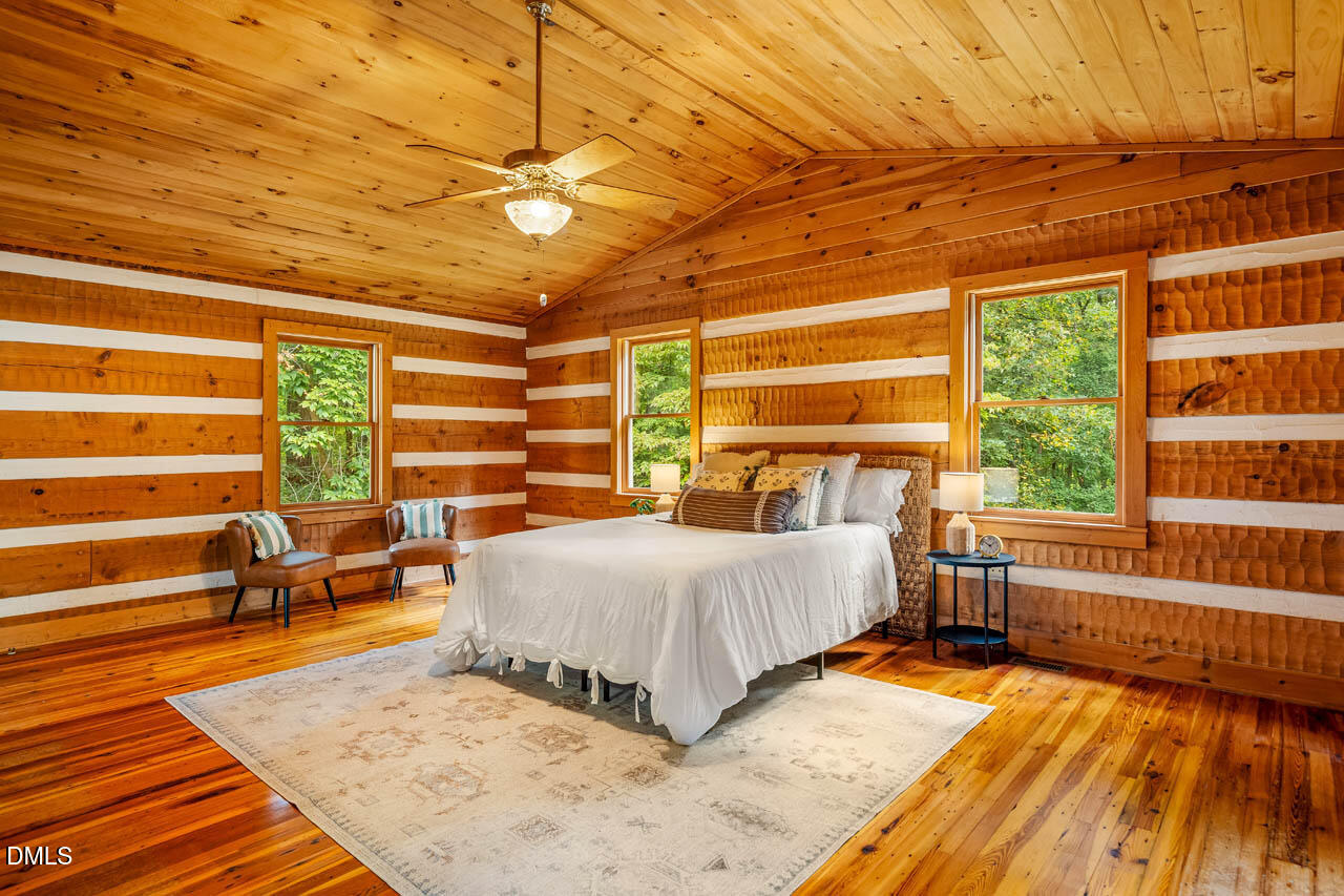 1114 Phil's Ridge Road Chapel Hill, NC 27516 - Photo 18 of 52 a bedroom with a bed and wooden floor