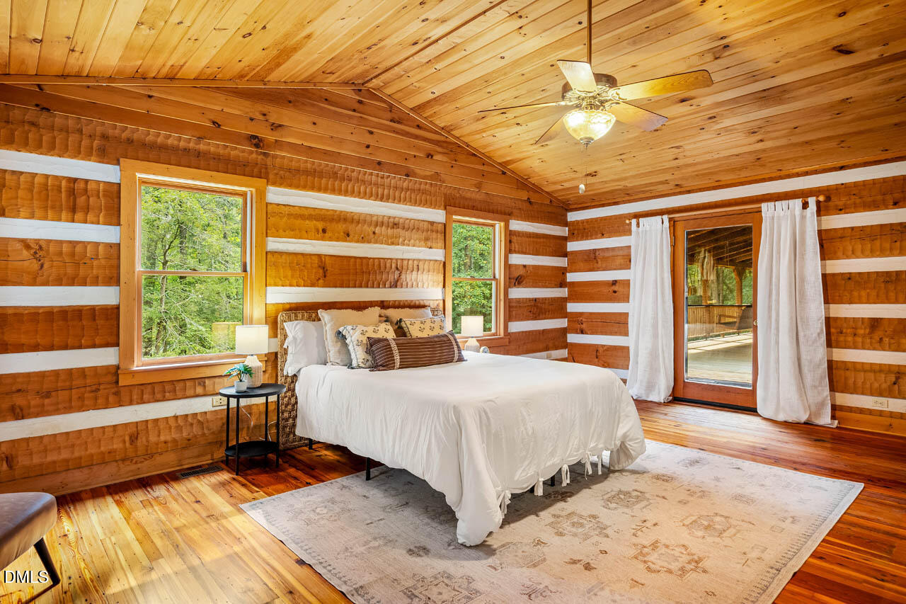 1114 Phil's Ridge Road Chapel Hill, NC 27516 - Photo 19 of 52 a bedroom with a large bed and a window