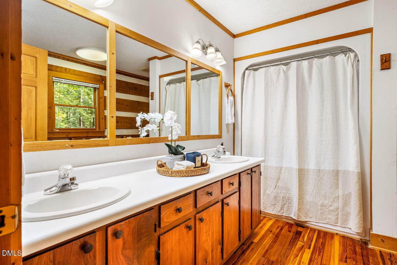 1114 Phil's Ridge Road Chapel Hill, NC 27516 - Photo 21 of 52 a bathroom with a sink and a mirror