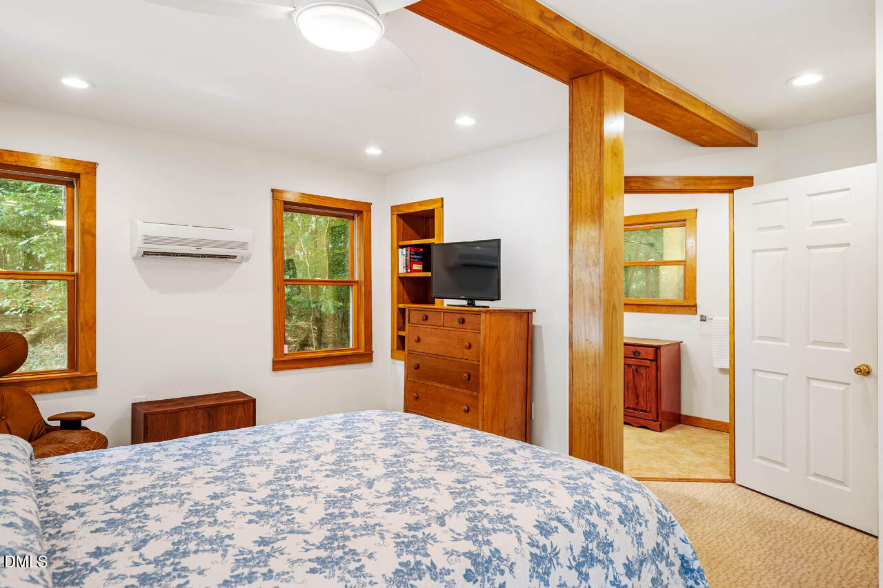 1114 Phil's Ridge Road Chapel Hill, NC 27516 - Photo 35 of 52 a bedroom with a bed and wooden floor