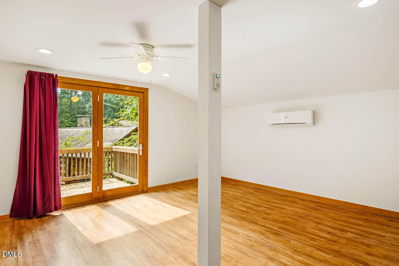1114 Phil's Ridge Road Chapel Hill, NC 27516 - Photo 38 of 52 a view of a room with wooden floor and windows