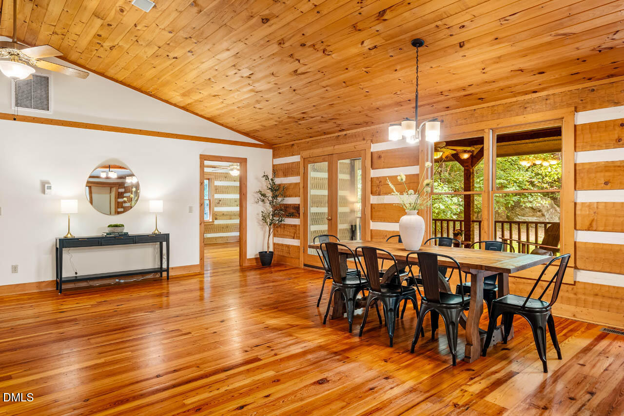 1114 Phil's Ridge Road Chapel Hill, NC 27516 - Photo 9 of 52 a view of a dining room with furniture and wooden floor