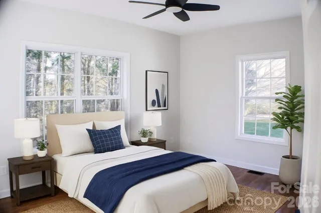 a bedroom with a large bed and a window