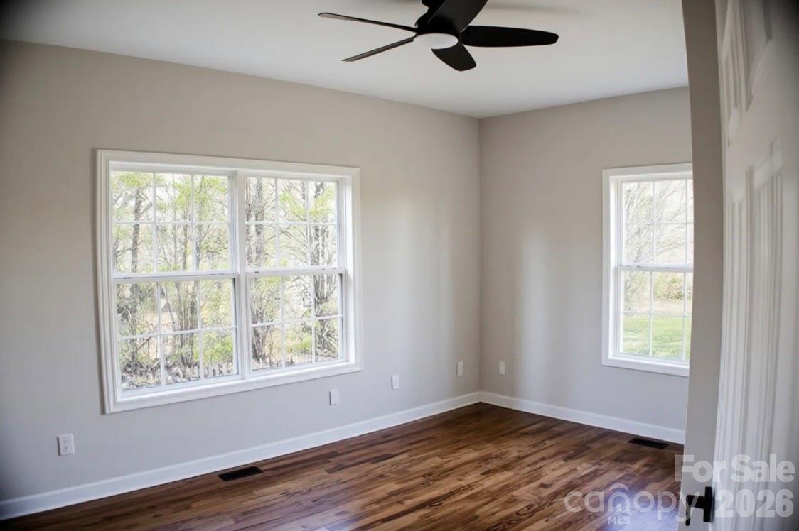 1304 Overhill Road Salisbury, NC 28144 - Photo 16 of 24 a view of an empty room with wooden floor and a window
