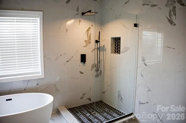 a bathroom with a bathtub and shower