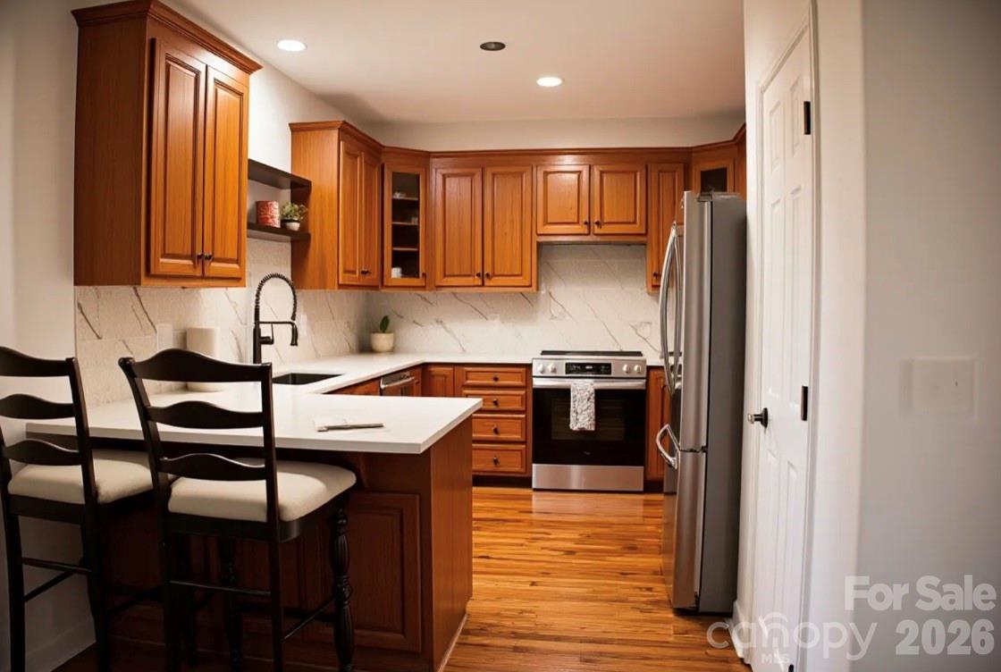 1304 Overhill Road Salisbury, NC 28144 - Photo 8 of 24 a kitchen with stainless steel appliances granite countertop a sink and a refrigerator