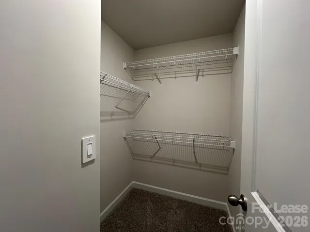 a view of storage and utility room with racks on the wall