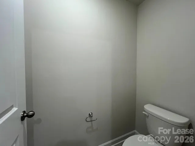 a white toilet sitting in a bathroom