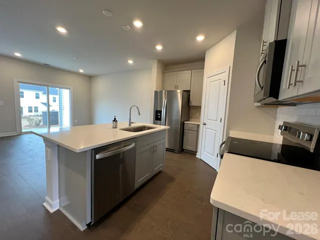 a kitchen with refrigerator and window