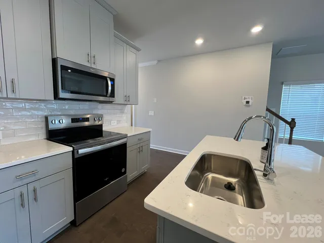 a kitchen that has a sink and a stove