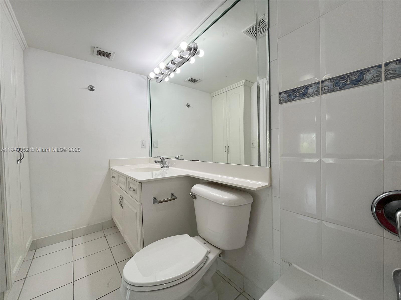 2415 Northwest 16th St Road, Unit 3031 Miami, FL 33125 - Photo 16 of 22 a bathroom with a toilet sink and mirror