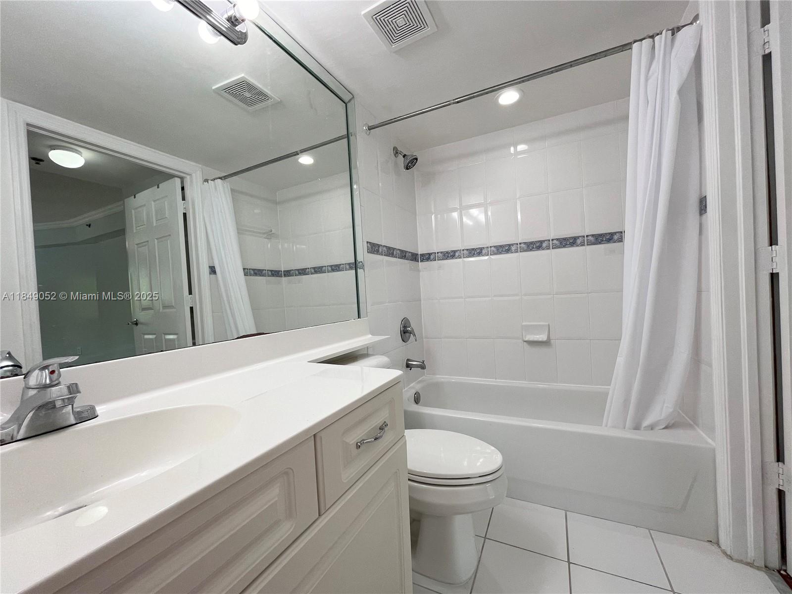 2415 Northwest 16th St Road, Unit 3031 Miami, FL 33125 - Photo 17 of 22 a bathroom with a sink a toilet and shower