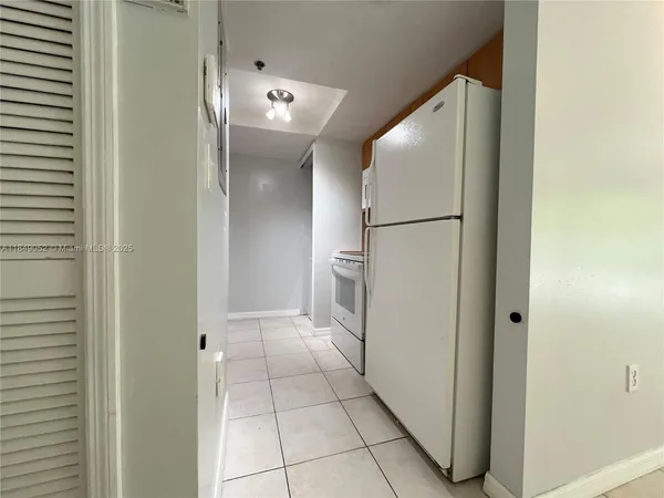 a view of a hallway with closet and entryway