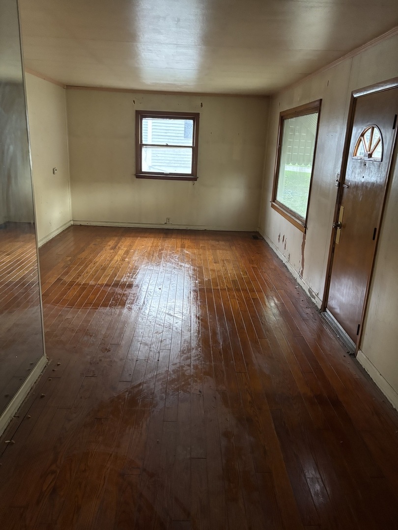 1010 Helen Avenue Joliet, IL 60433 - Photo 2 of 11 an empty room with wooden floor and windows
