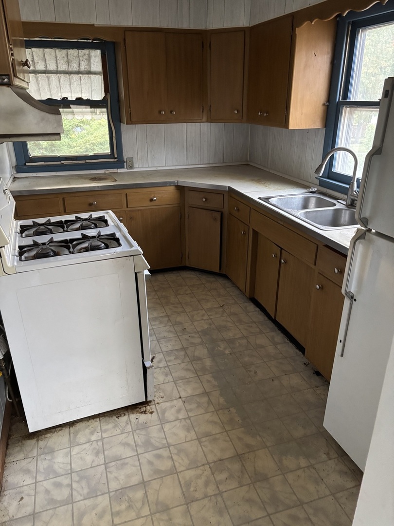 1010 Helen Avenue Joliet, IL 60433 - Photo 3 of 11 a kitchen with stainless steel appliances granite countertop a stove a sink and a microwave