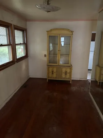 a view of a room with wooden floor and a window