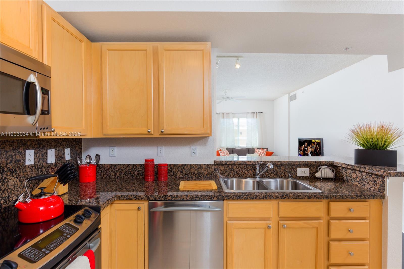 6001 Southwest 70th Street, Unit 610 South Miami, FL 33143 - Photo 5 of 18 a kitchen with stainless steel appliances granite countertop a sink a stove and cabinets