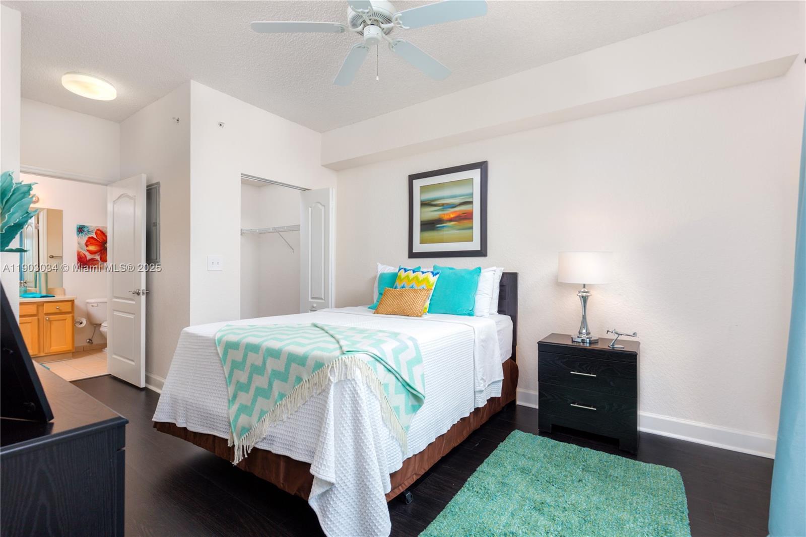 6001 Southwest 70th Street, Unit 610 South Miami, FL 33143 - Photo 8 of 18 a bedroom with a bed and a chandelier