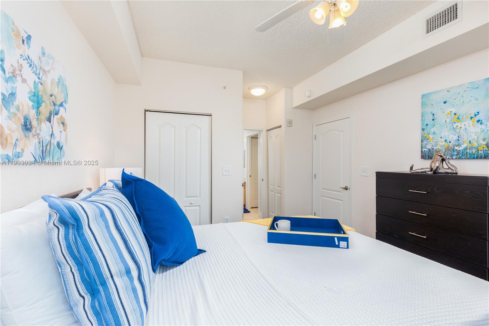 6001 Southwest 70th Street, Unit 610 South Miami, FL 33143 - Photo 10 of 18 a bedroom with a bed and painting on the wall