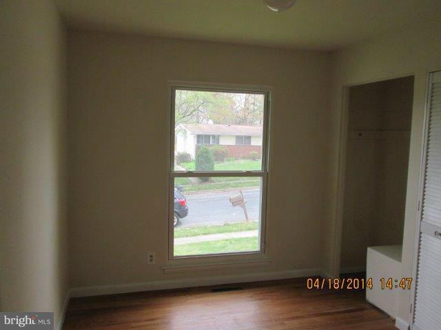 4700 Duncannon Road Baltimore, MD 21208 - Photo 12 of 15 a view of an empty room with wooden floor and a window
