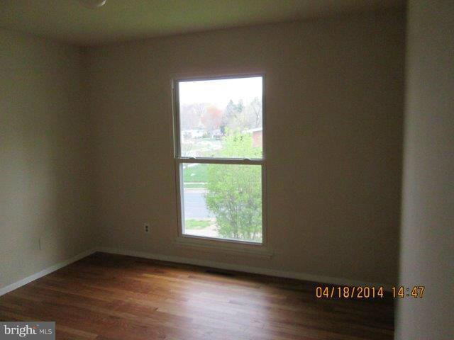 4700 Duncannon Road Baltimore, MD 21208 - Photo 14 of 15 an empty room with wooden floor and windows