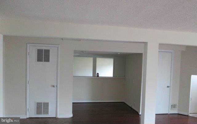 4700 Duncannon Road Baltimore, MD 21208 - Photo 8 of 15 a view of an empty room with wooden floor and a window