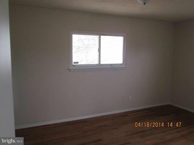 4700 Duncannon Road Baltimore, MD 21208 - Photo 9 of 15 a view of an empty room with wooden floor and a window