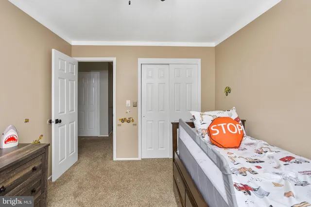 a bedroom with a bed and a dresser